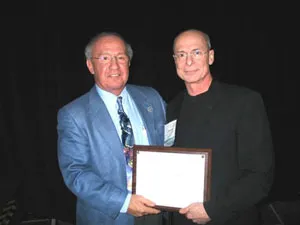 Dr. Niamtu receiving the President's Award from the American Academy of Cosmetic Surgery.