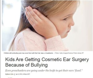 photo of a small girl covering her ear